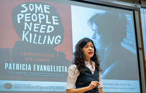 Patricia Evangelista speaking in front of an image of her book "Some People Need Killing"