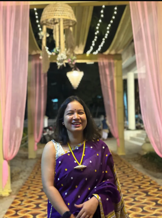 Dixita Deka posing in cultural attire, smiling towards the camera.