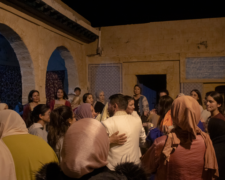 A crowd of people surrounding dancers.