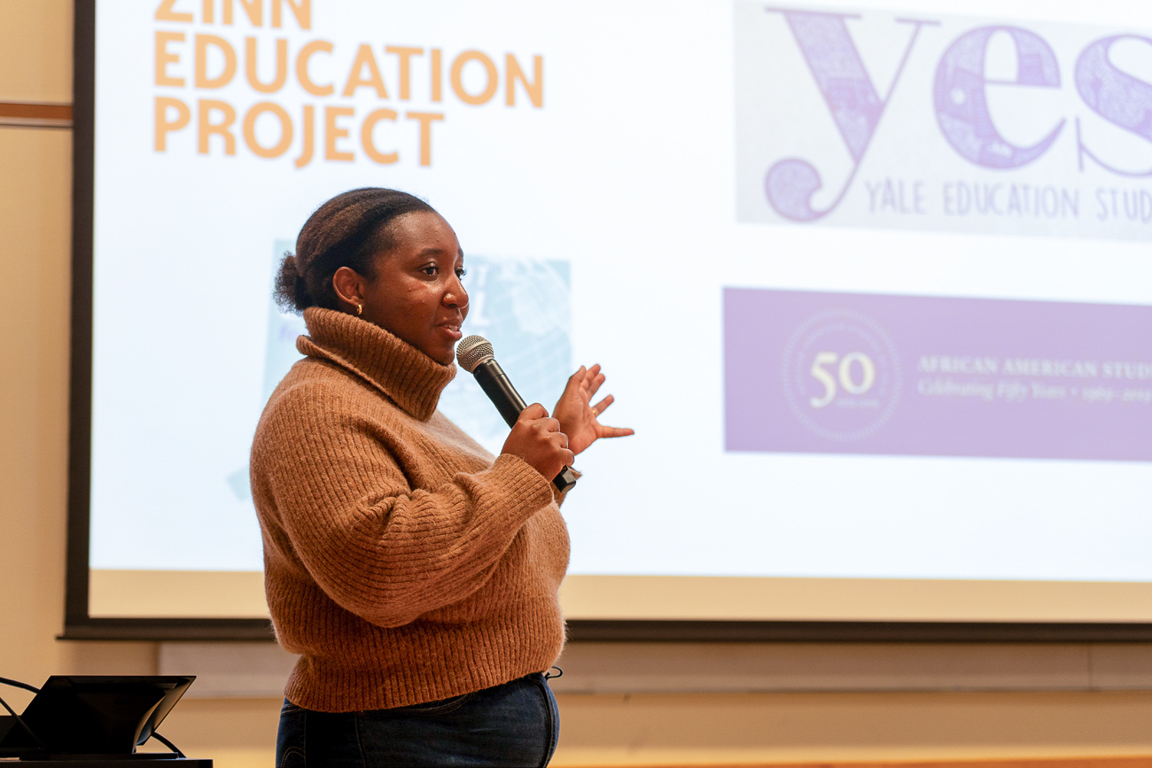 Daisha Brabham leading a workshop on reconstruction standing in the front of a classroom.