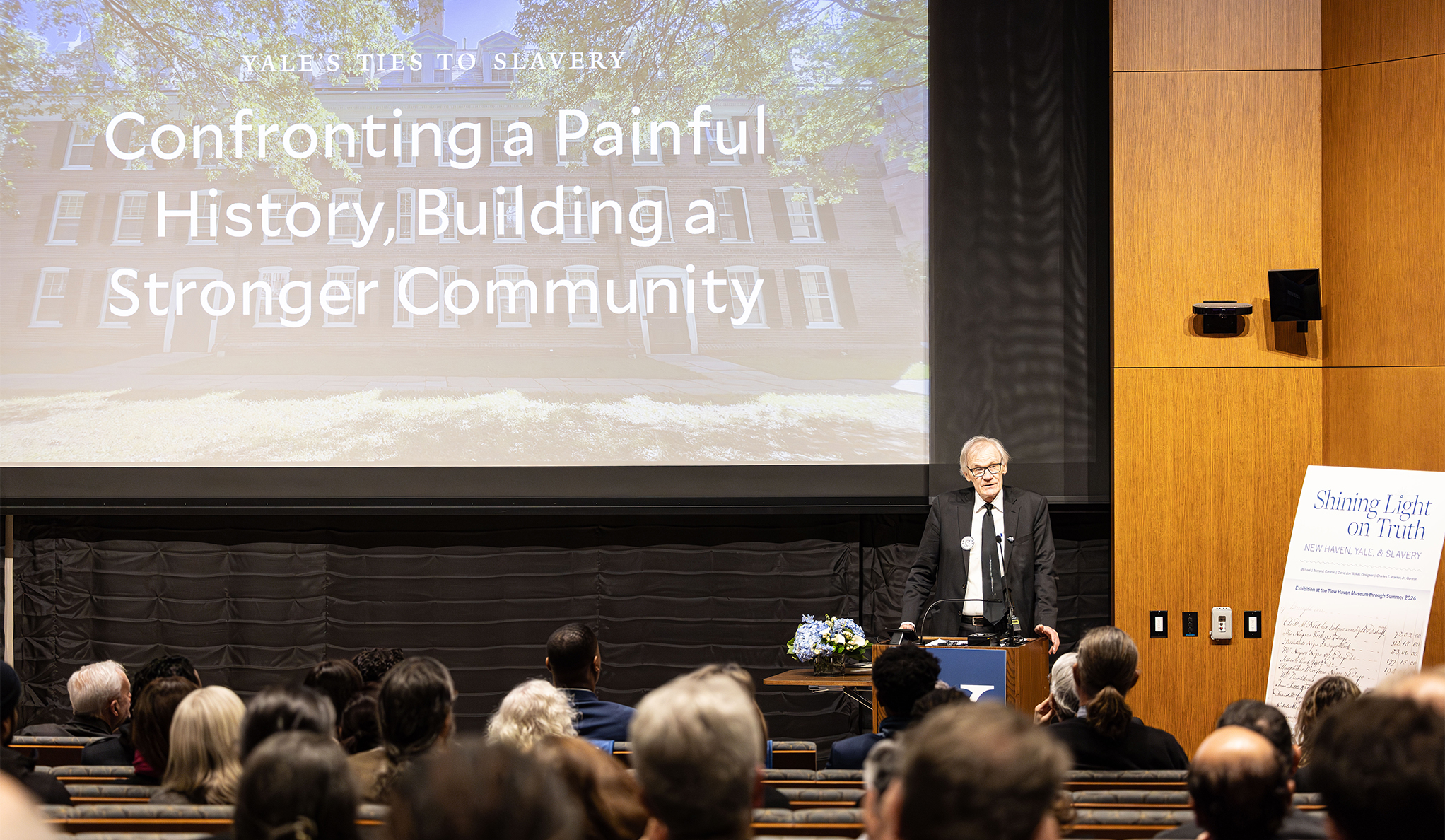 David Blight at the front of a crowded room giving a talk at a Yale and Slavery Book Launch event.