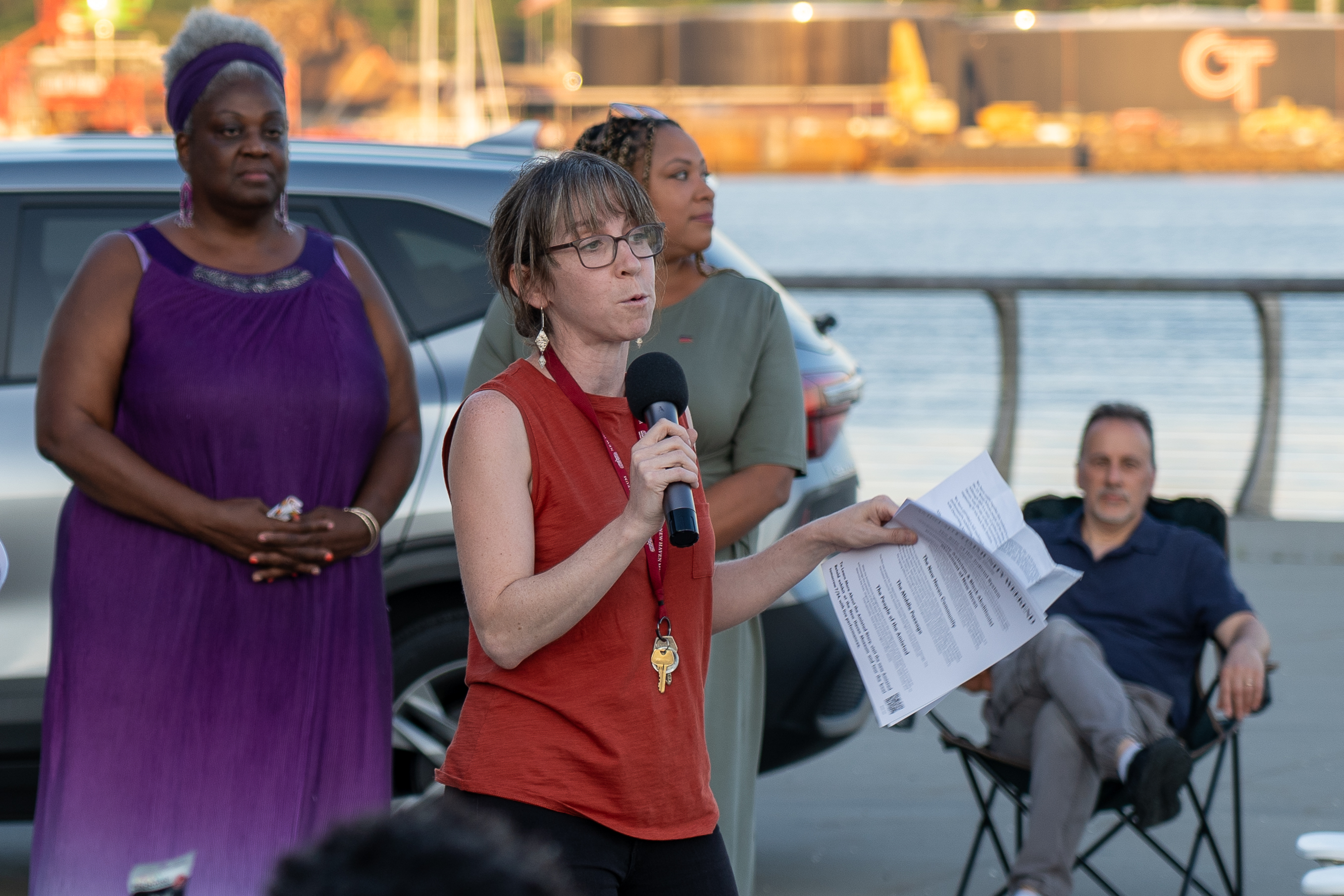 Joanna Steinberg introducing the movie Amistad at a community screening that took place in a harbor
