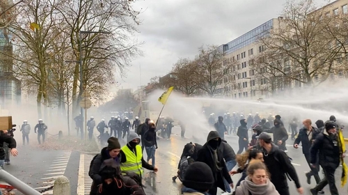Police water cannon firing at protesters in Brussels Sunday.
