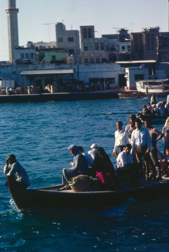 Fig. 1 “Ferry in Dubai Harbor, 1970” shows men commuting to work in an abra (water taxi), in the Dubai Creek. Eve Arnold for Magnum Photos, courtesy of Magnum Photos/Beinecke Rare Books and Manuscript Library, Yale University.