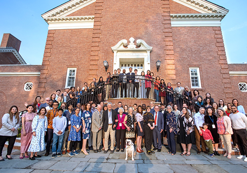Large group photo outdoors in front of the Yale Divinity Marquand Chapel
