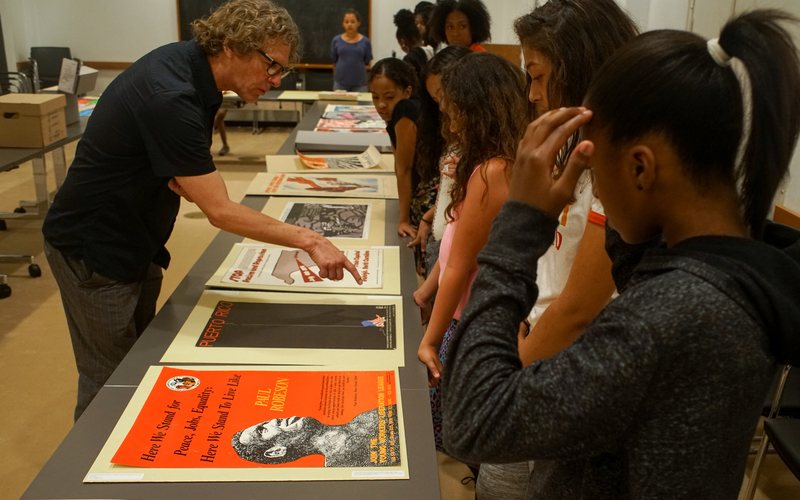 Tom Thurston teaches a group of New Haven youth about Black and Latino history through primary documents at Yale