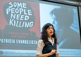 Patricia Evangelista speaking in front of an image of her book "Some People Need Killing"