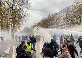 Police water cannon firing at protesters in Brussels Sunday.