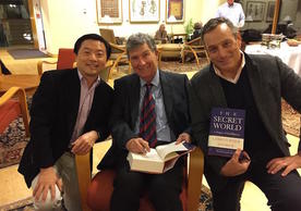Christopher Andrew (middle) signing copies of his new book "The Secret World: A History of Intelligence" on which his lectures were based.