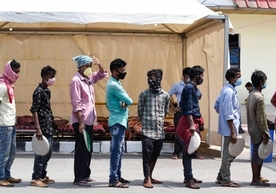 Migrants wait in queues to receive food being distributed by the volunteers outside the Railway Station during in Guwahti, Assam, 4 June, 2020. Photo by Talukdar David, Shutterstock