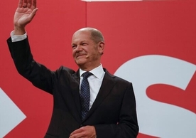 SPD leader Olaf Scholz greeting celebrating party members Sunday evening.