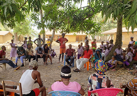 Y-RISE researchers and partners gathered in a circle in rural Sierra Leone