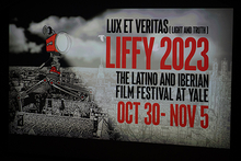A film screen projecting the film festival poster