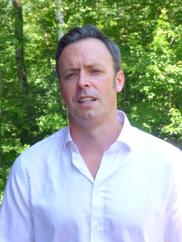 Connolly in white collared shirt outdoors