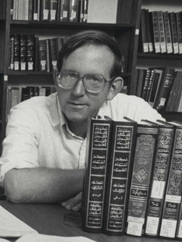 Dr. Foster posing with books