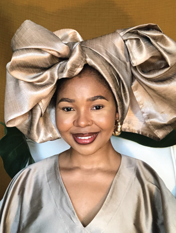 Nandipa Sipengane smiling in glossy outfit