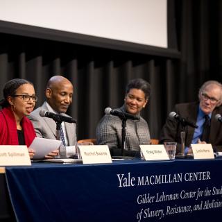 Five panelists converse in Luce Hall Auditorium.