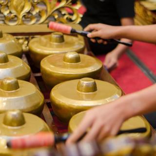 Hands playing a Gamelan instrument in Malaysia