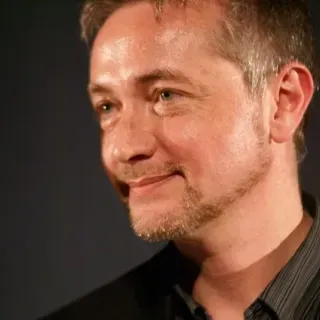 Yuri Kordonsky smiling in black suit