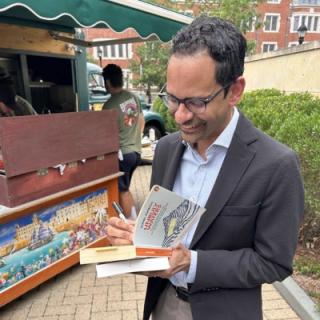 Sunil Amrith is signing his book.