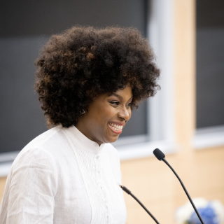 Chimamanda Ngozi Adichie '08 delivers the 2025 Coca-Cola World Lecture inside an auditorium to a full crowd.