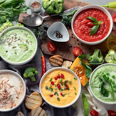 An array of vegetable soups displayed on a table
