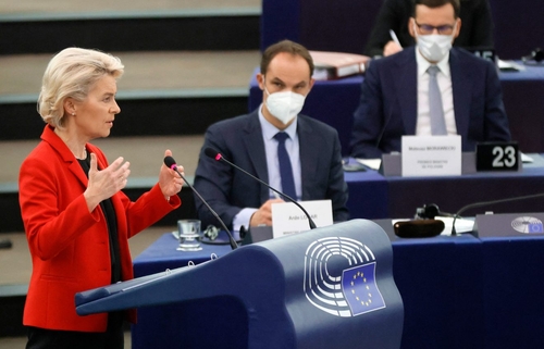 Commission President Ursula von der Leyen speaking at the European Parliament yesterday as Polish Prime Minister Mateusz Morawiecki (on the right) listens.