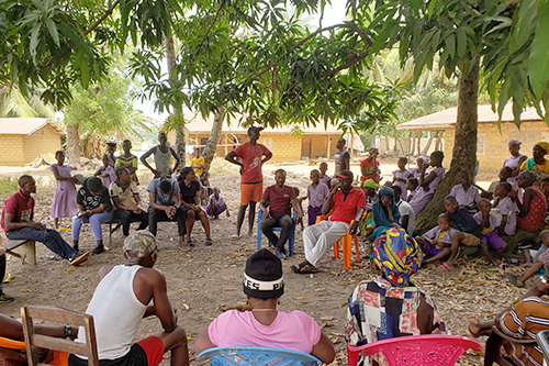 Y-RISE researchers and partners gathered in a circle in rural Sierra Leone